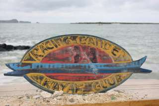 Here is a hand made weathered wooden sign RACING CANOE, KAYAK CLUB 