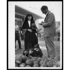  A nun purchasing watermelons from vendor,Rome,Italy