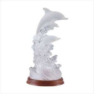 This artistic frosted sculpture features a pair of balletic dolphins 