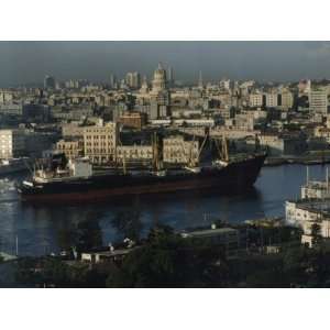 City and a Massive Freighter as It Cruises the Canal, Havana, Cuba 