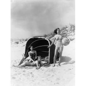 Three Women on Beach, Two Are Under Canvas Sun Screen, Other is 