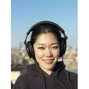  Young Woman Smiles While Listening to Her Headphones 