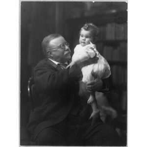  President Roosevelt,Theodore,holding,infant grandchild,seated,books 