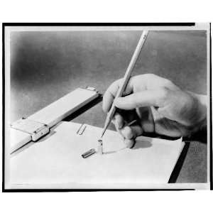    Hand holding pencil over transistor,slide rule 1949